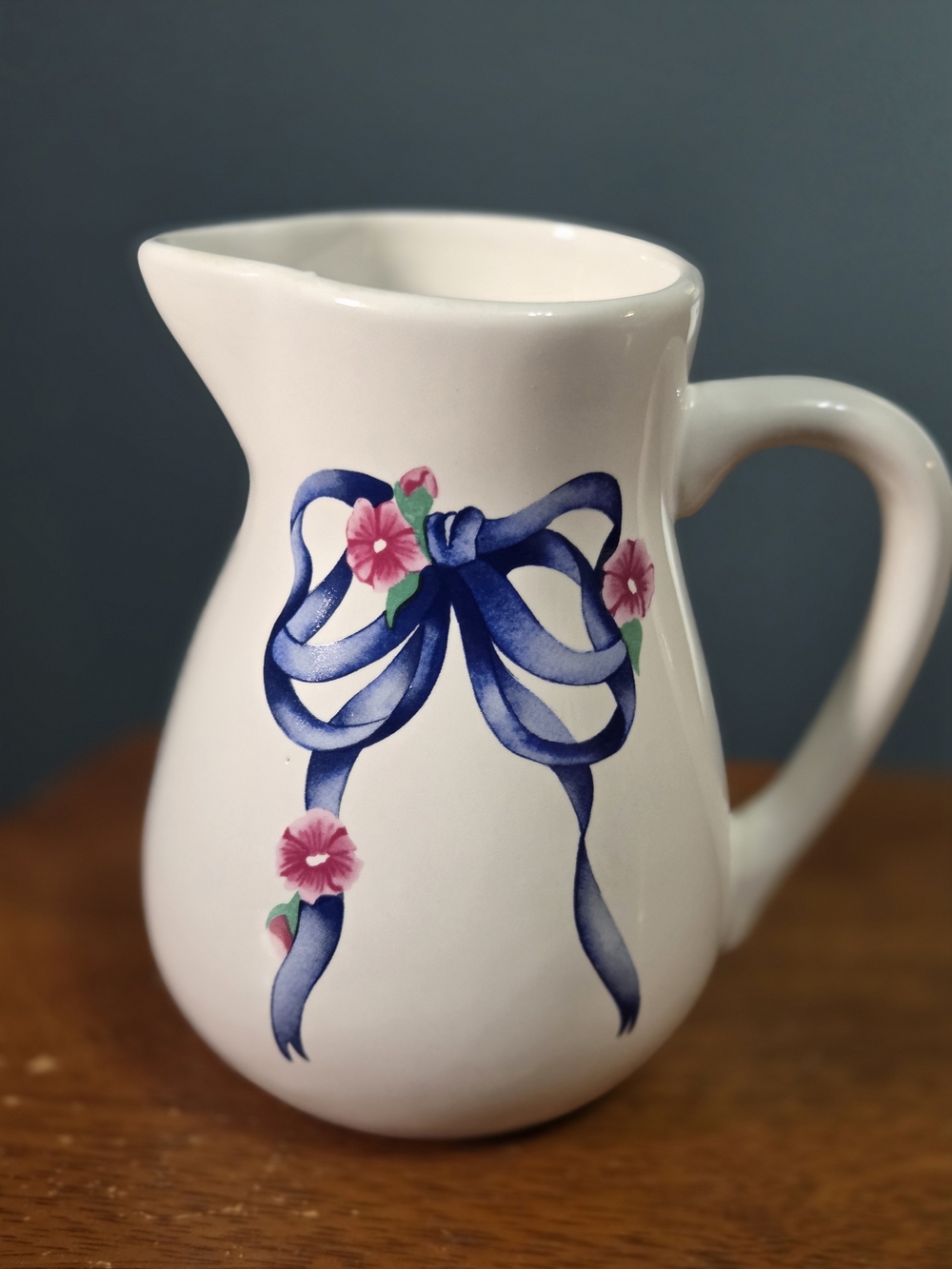 Vintage White Ceramic Pitcher with Blue Ribbon and Pink Floral Accents